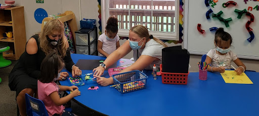 Two ladies teaching games to children